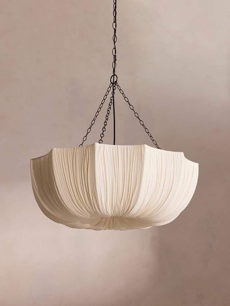1 Modern retro pleated fabric pendant chandelier in cream, hanging with black chains against a neutral wall, ideal for living room and dining room decor