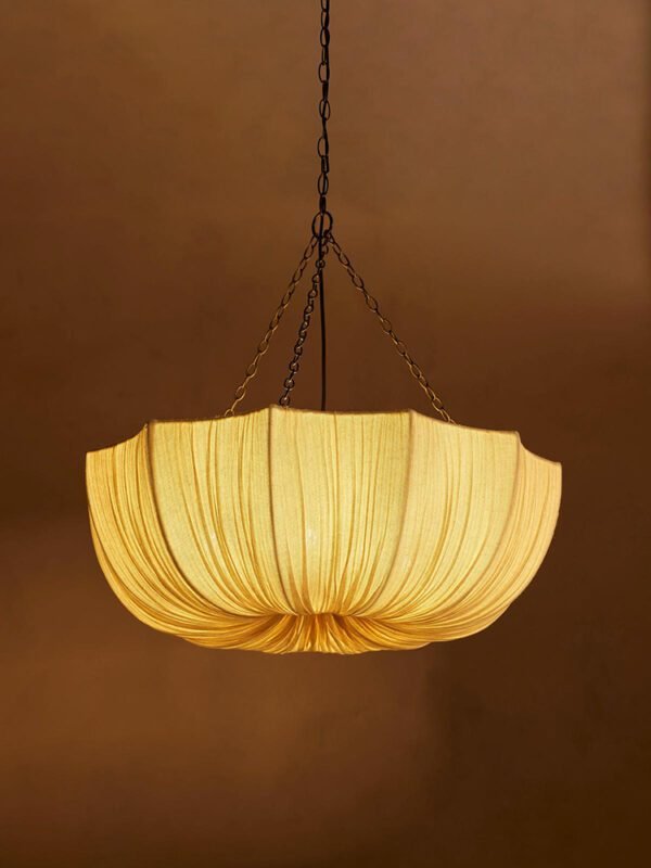 Modern retro pleated fabric pendant chandelier in cream, hanging with black chains against a neutral wall, ideal for living room and dining room decor
