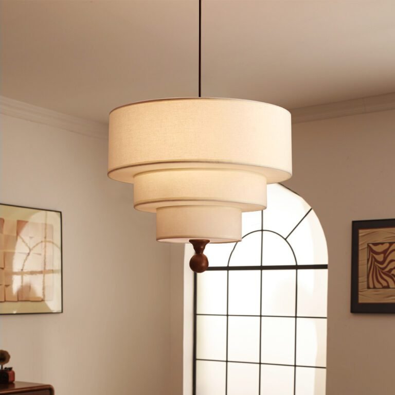 Retro modern multi-layer linen drum pendant light with green and beige fabric shades, hanging in a room with an arched window and abstract art, ideal for living room and dining room decor