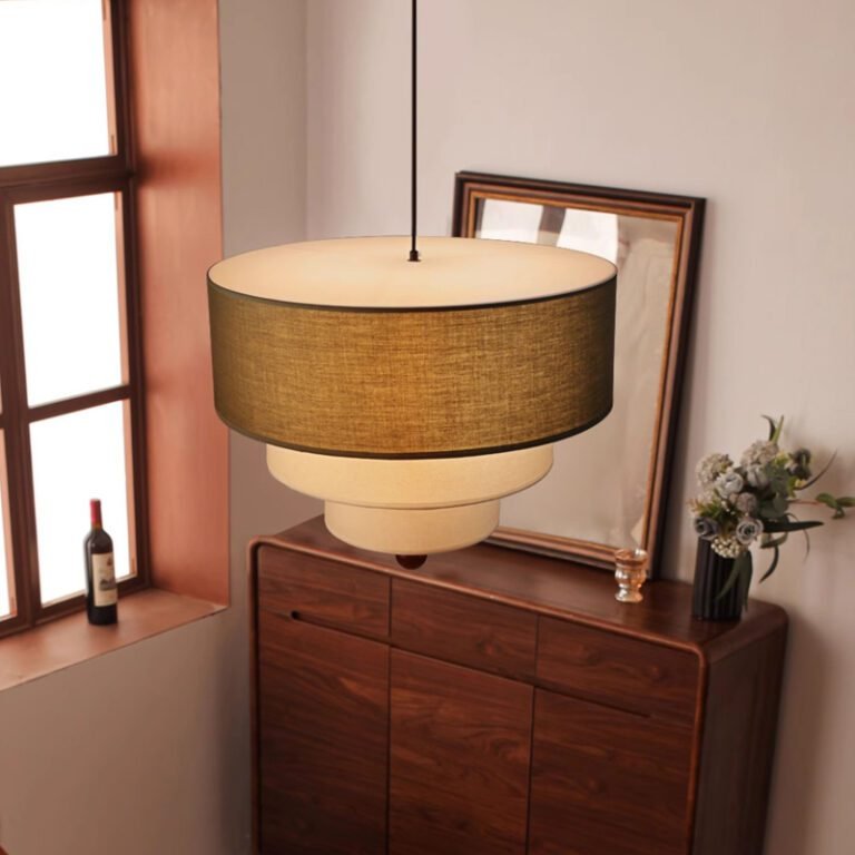 Retro modern multi-layer linen drum pendant light with green and beige fabric shades, hanging in a room with an arched window and abstract art, ideal for living room and dining room decor