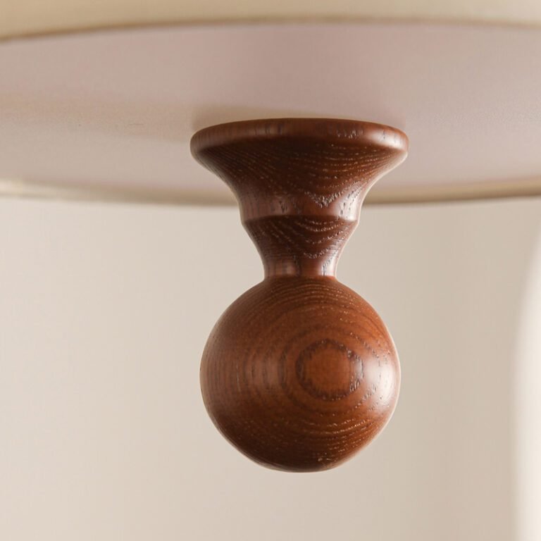 Retro modern multi-layer linen drum pendant light with green and beige fabric shades, hanging in a room with an arched window and abstract art, ideal for living room and dining room decor